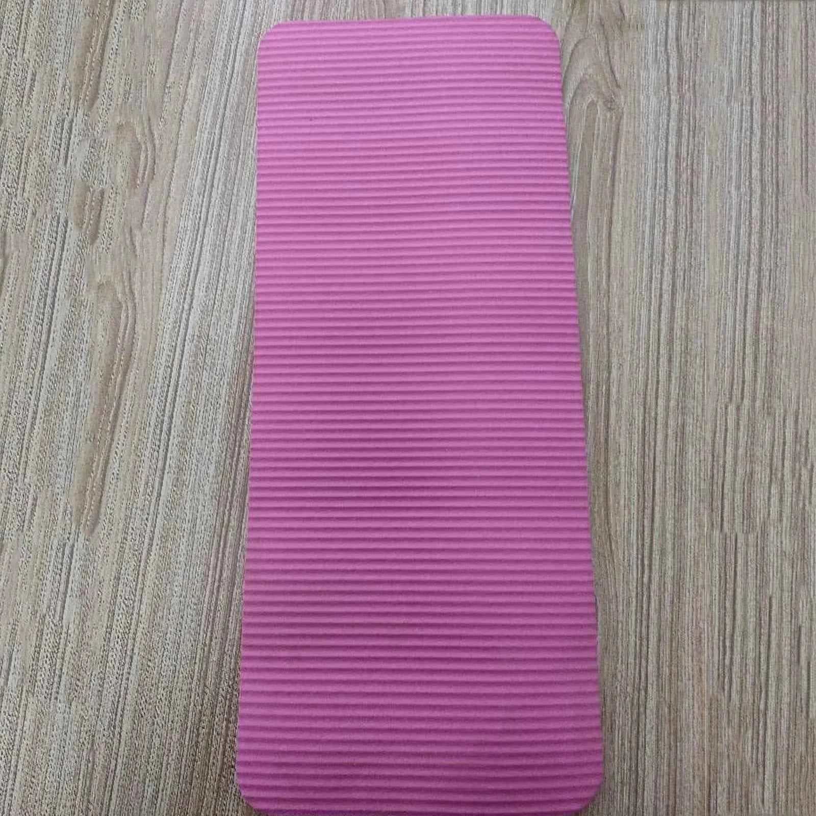 Pink mini yoga mat with textured anti-slip surface for compact exercise