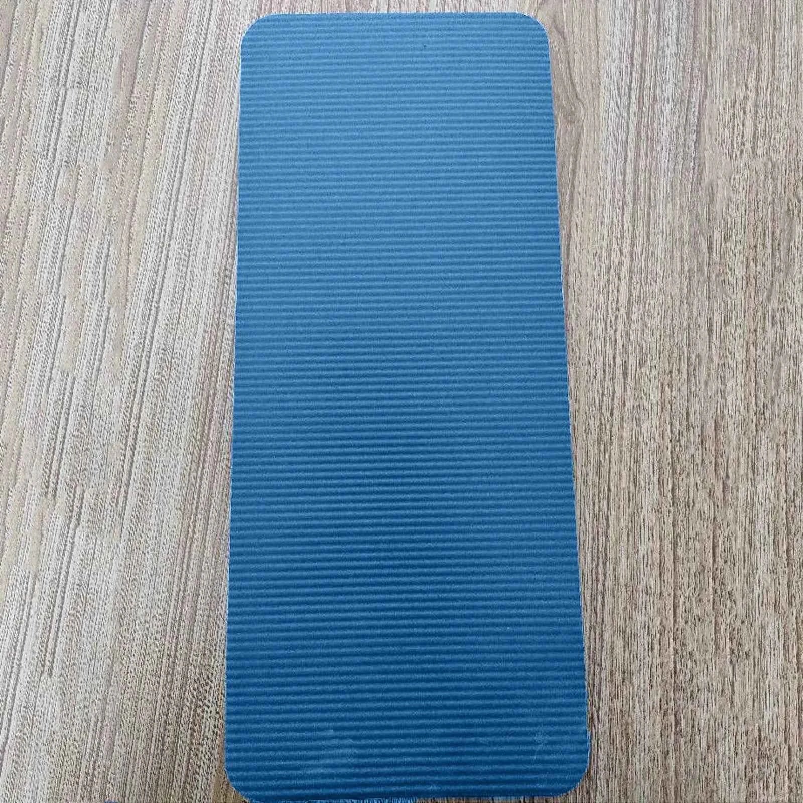 Blue compact mini yoga mat with textured anti-slip grip surface